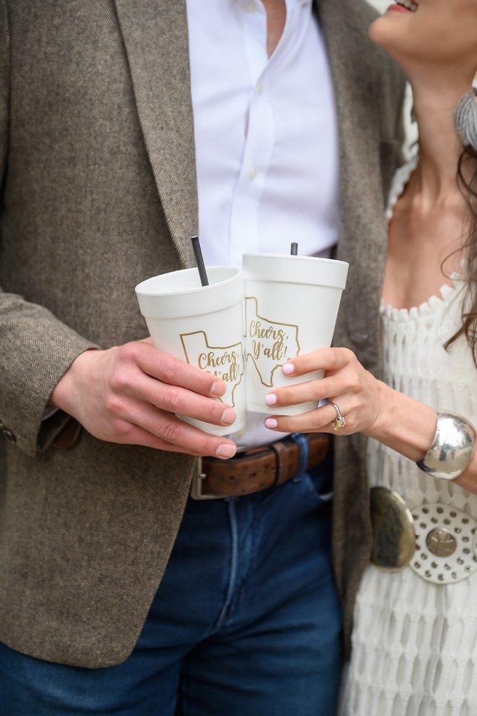 bride and groom holding cups at the rehearsal dinner