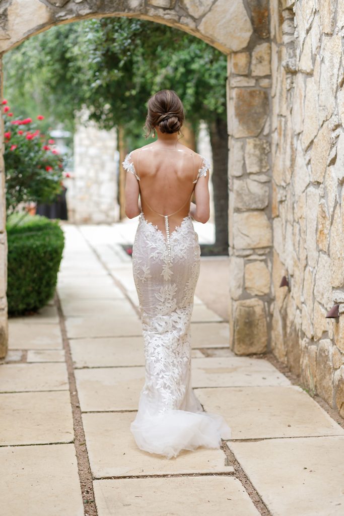bride in a backless lace wedding gown