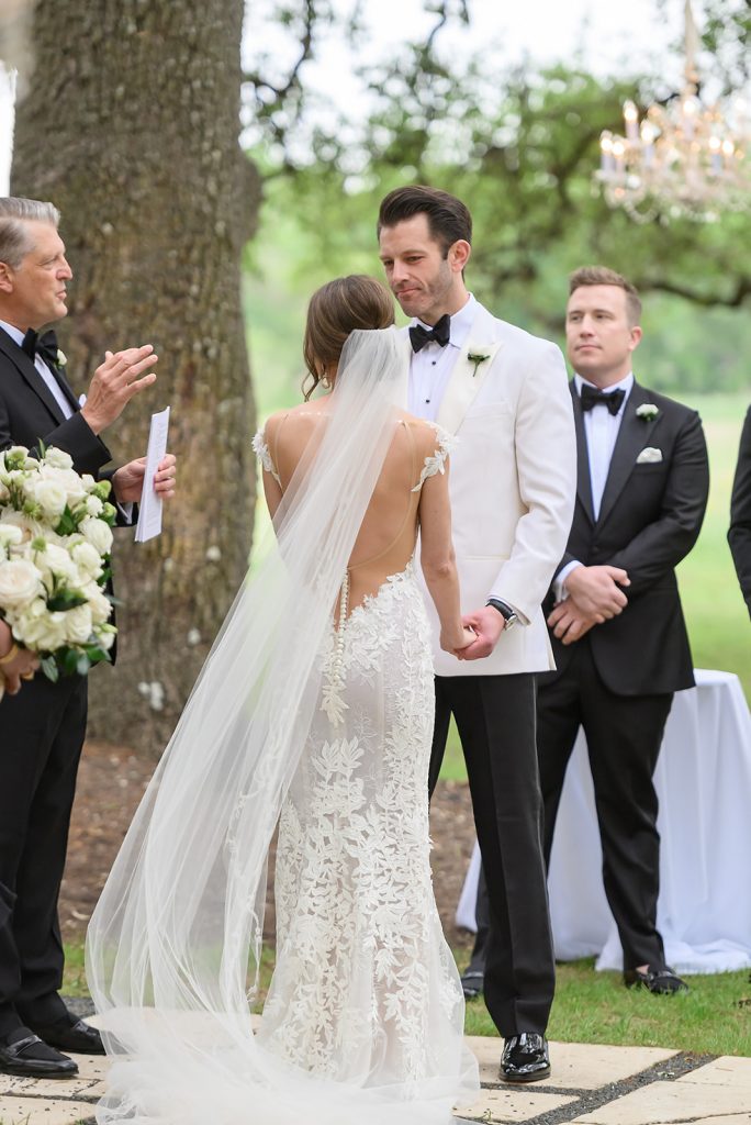 bride and groom holding hands at the altar