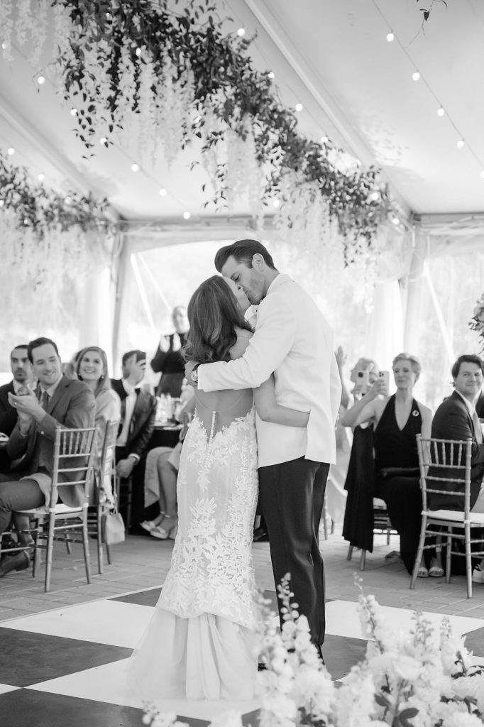 bride and groom kissing as they entire the reception