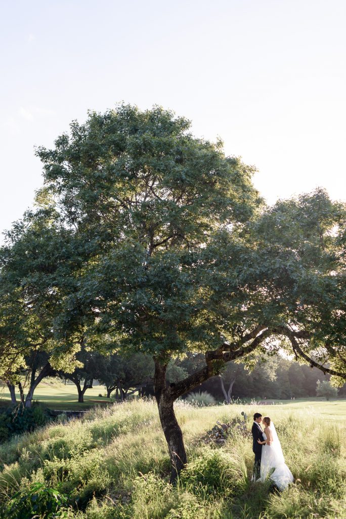 Bride and groom under the tree at Omni Barton Creek Wedding
