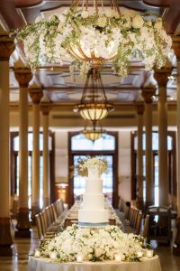 Wedding cake displayed along The Driskill mezzanine with historic architectural details