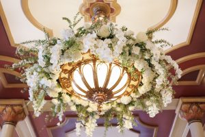 Floral installation surrounding a historic light fixture on The Driskill mezzanine