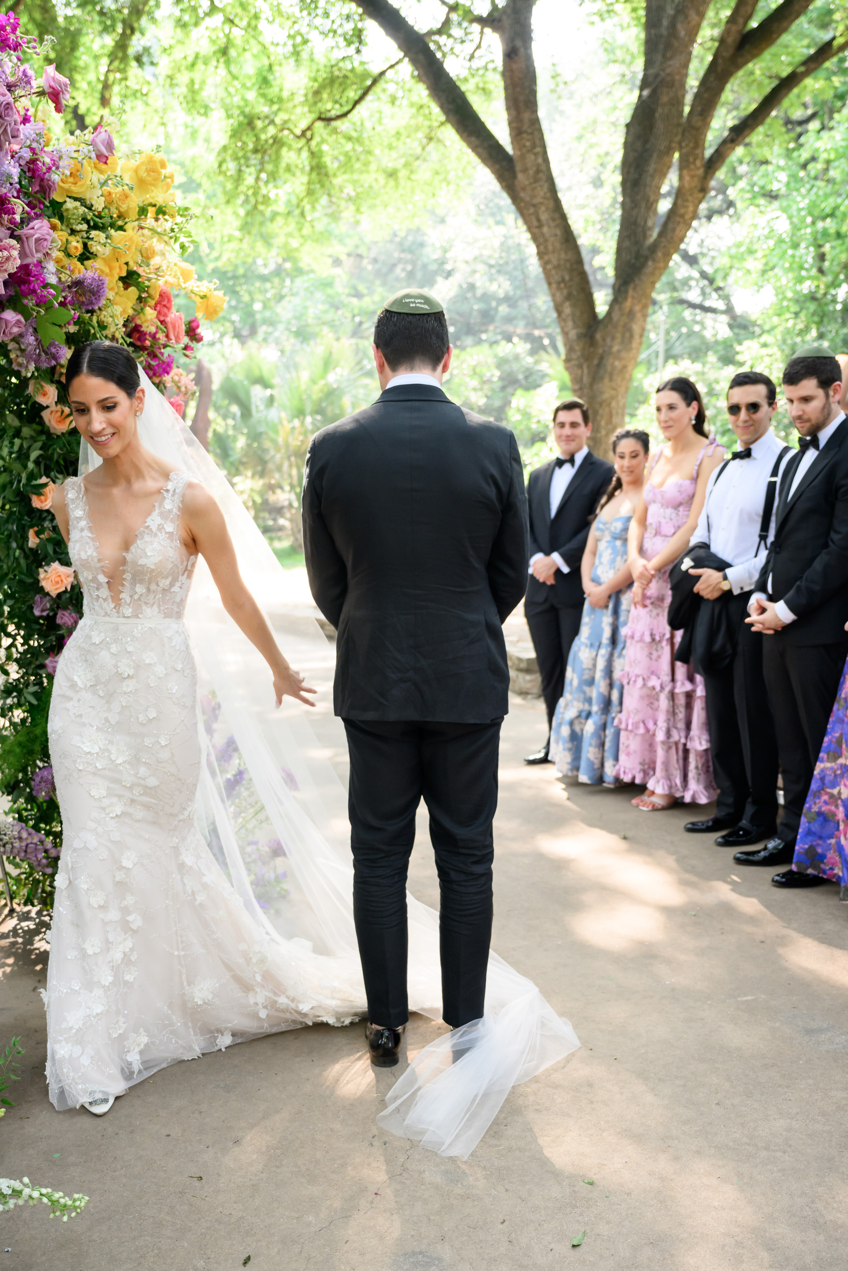 Bride entering her outdoor wedding ceremony in the limestone Amphitheater at Laguna Gloria
