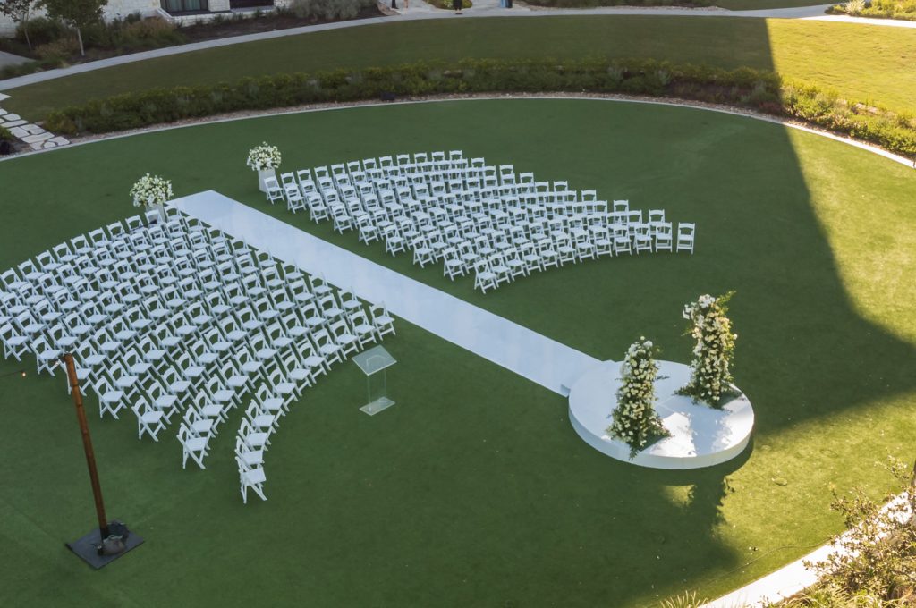 An outdoor wedding ceremony set up on a green lawn for Omni Barton Creek Resort