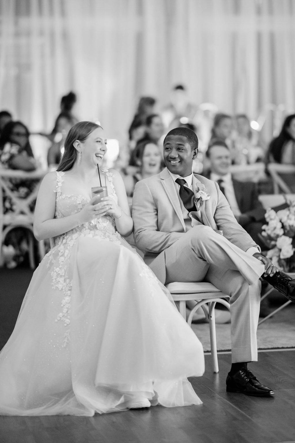 The bride and guests reacting to a heartfelt toast, surrounded by the candlelit ambiance of their luxury wedding reception at Horseshoe Bay Resort.