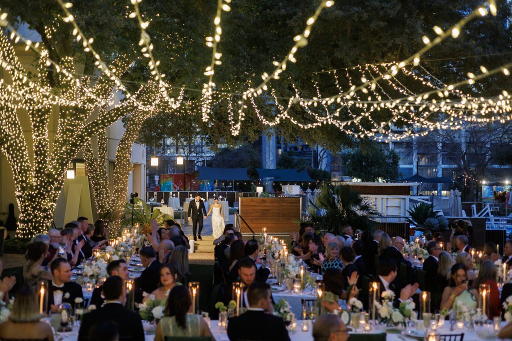 Evening wedding reception beneath string lights outdoors at Four Seasons Austin