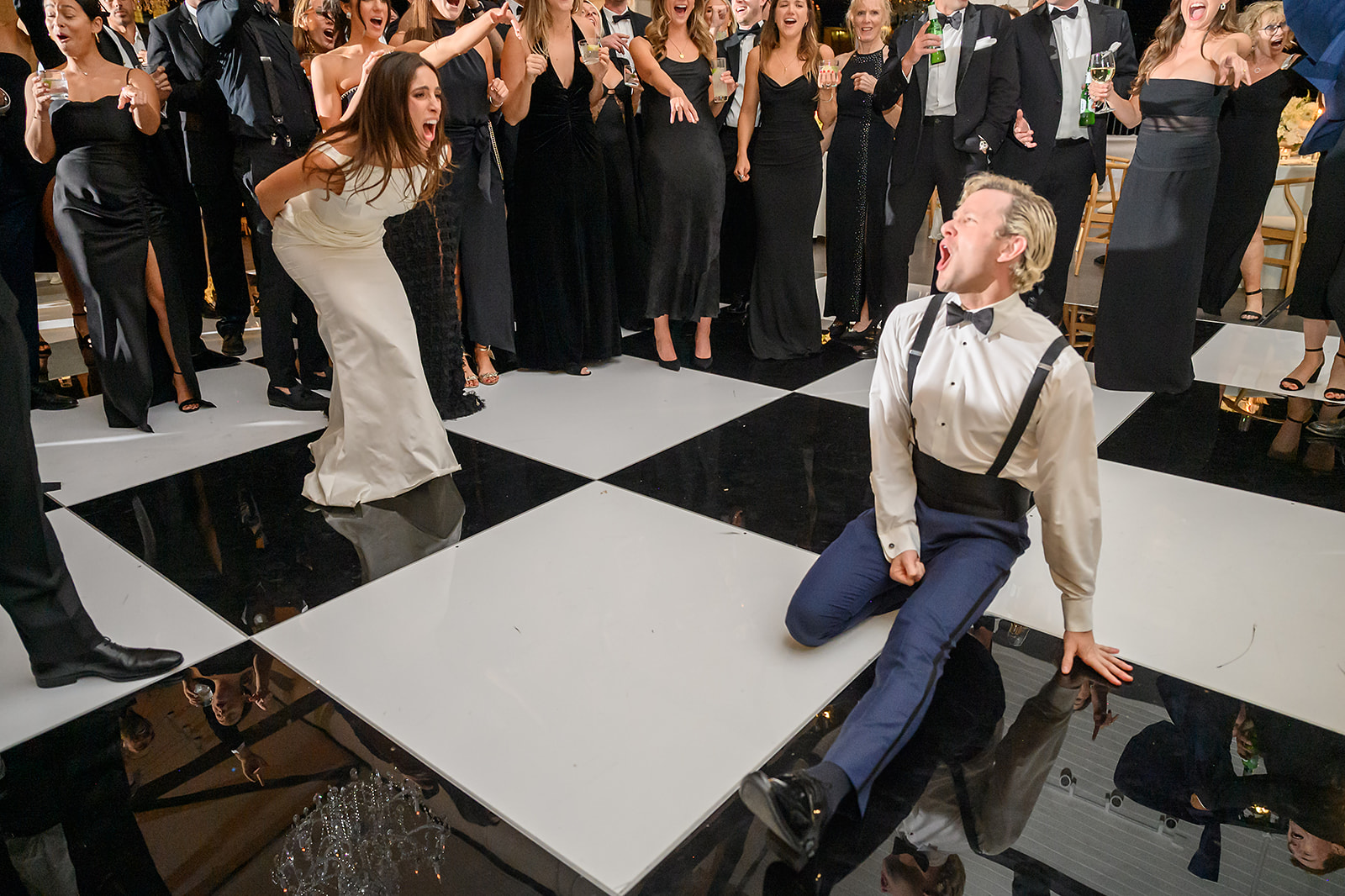 Wedding guests laughing and celebrating together during a lively reception