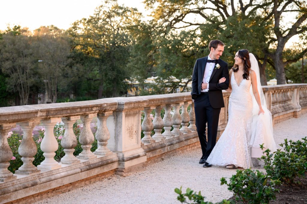 Couple walking along the gravel path with the stone bannister at Commodore Perry Estate