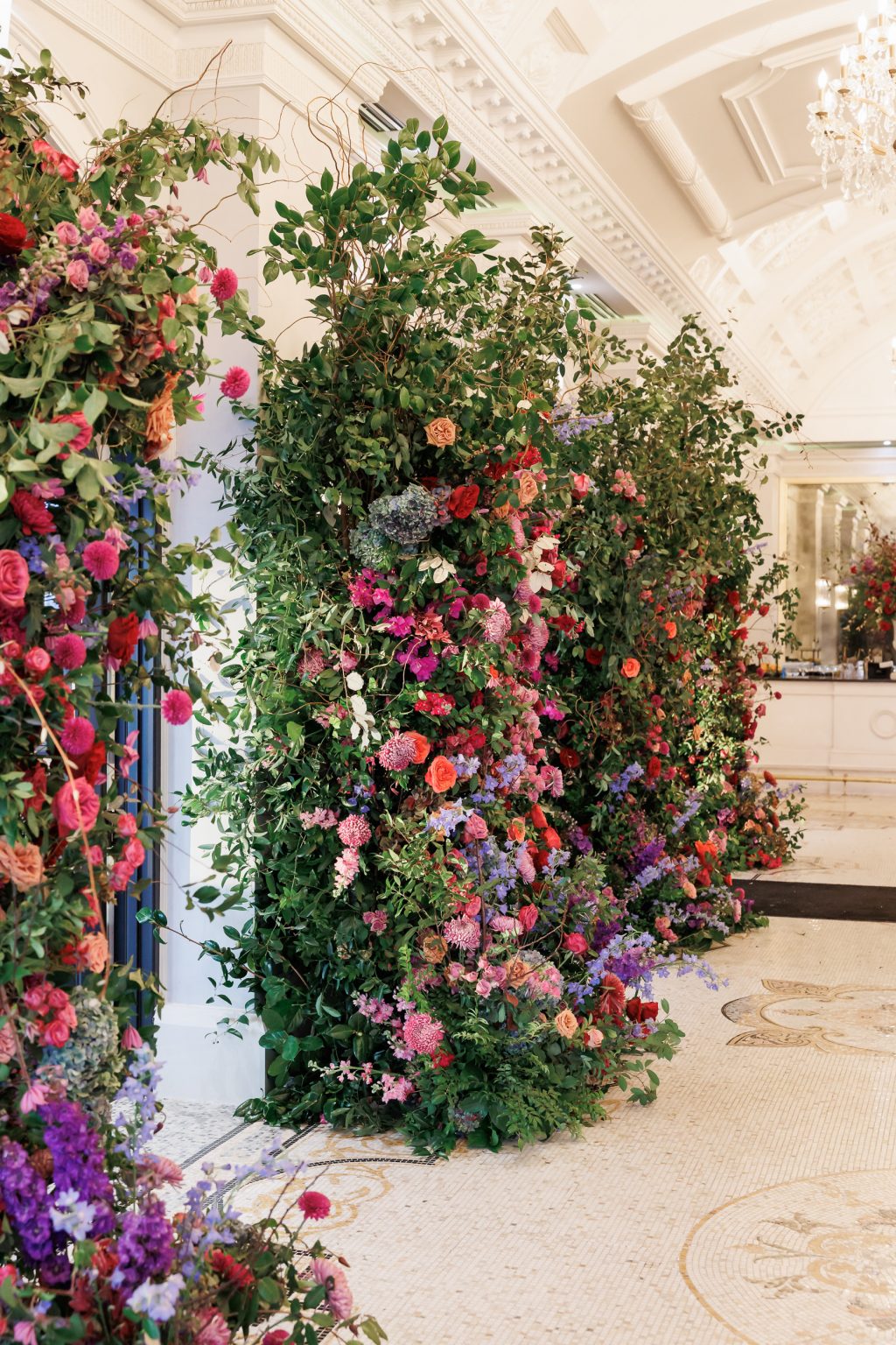 Statement floral installation with pink and red flowers at Bailey and Alton’s Houston wedding reception.