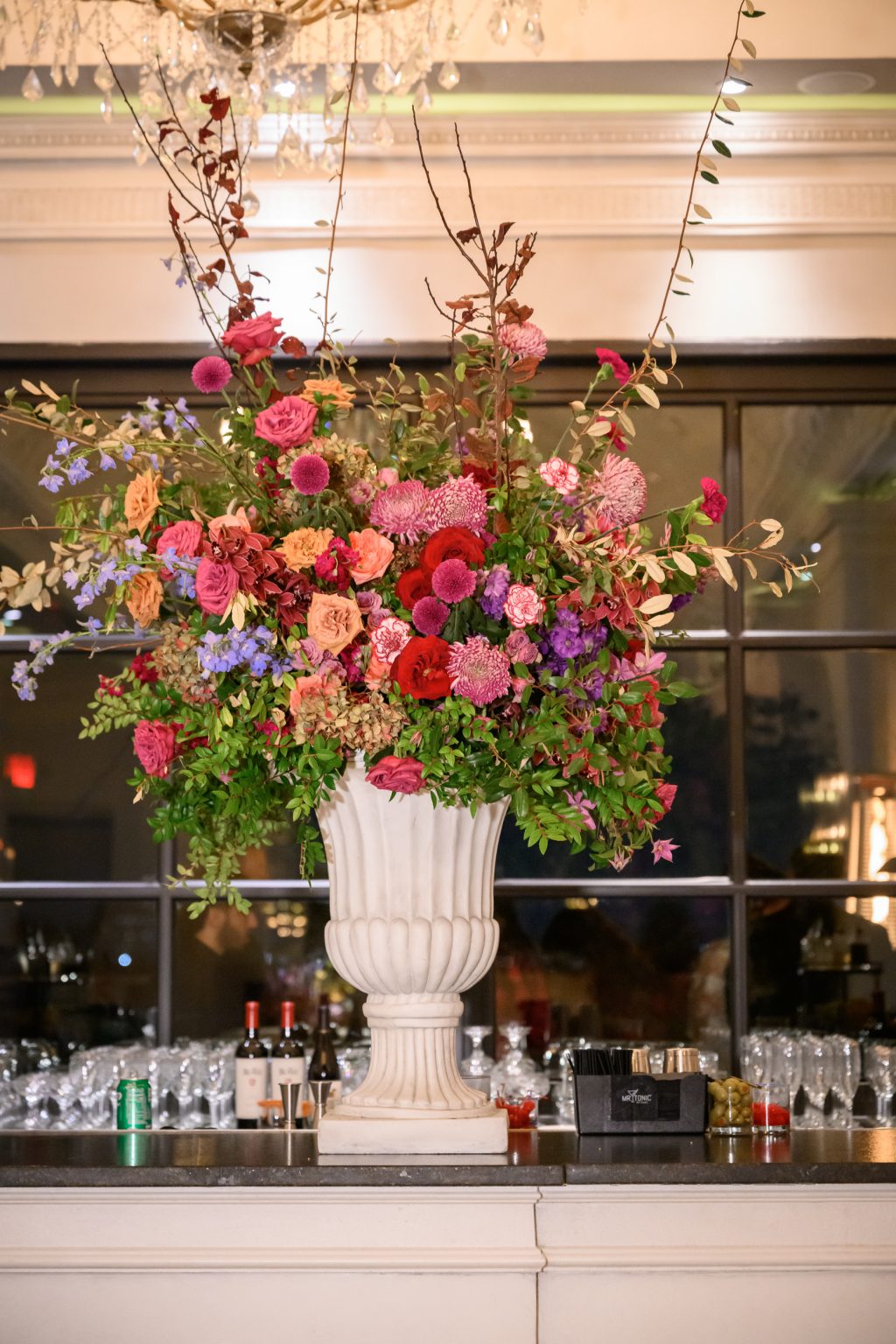 Pink and red floral arrangement displayed at the bar inside Le Tesserae.