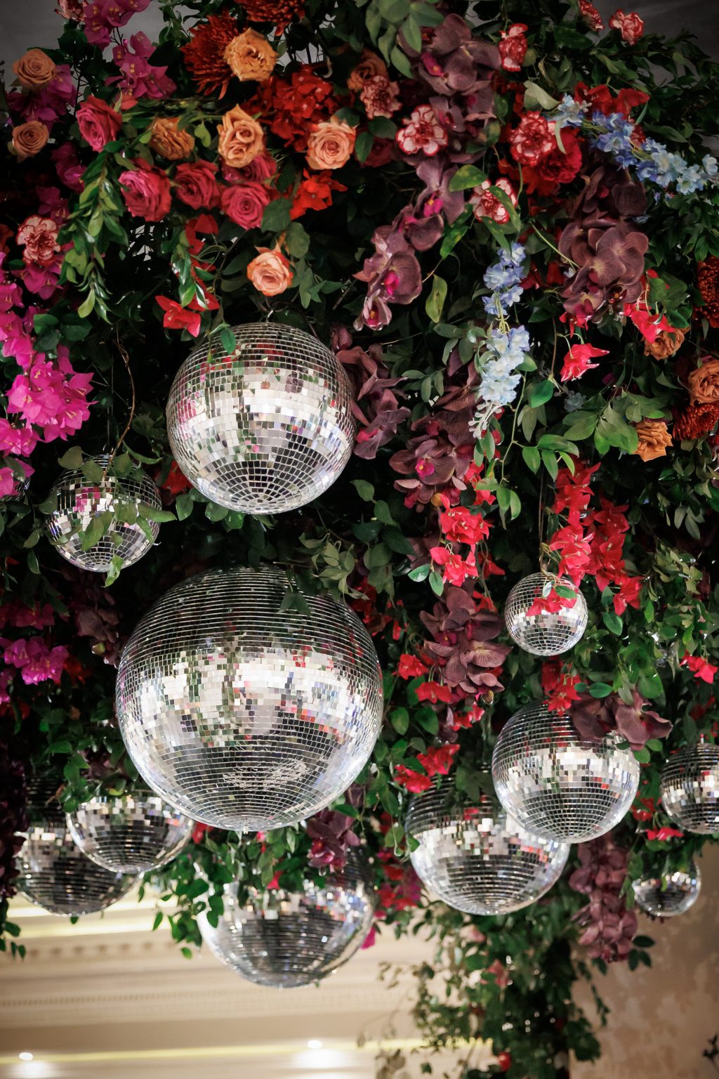 Hanging floral installation with reflective disco balls at Bailey and Alton’s Houston reception.