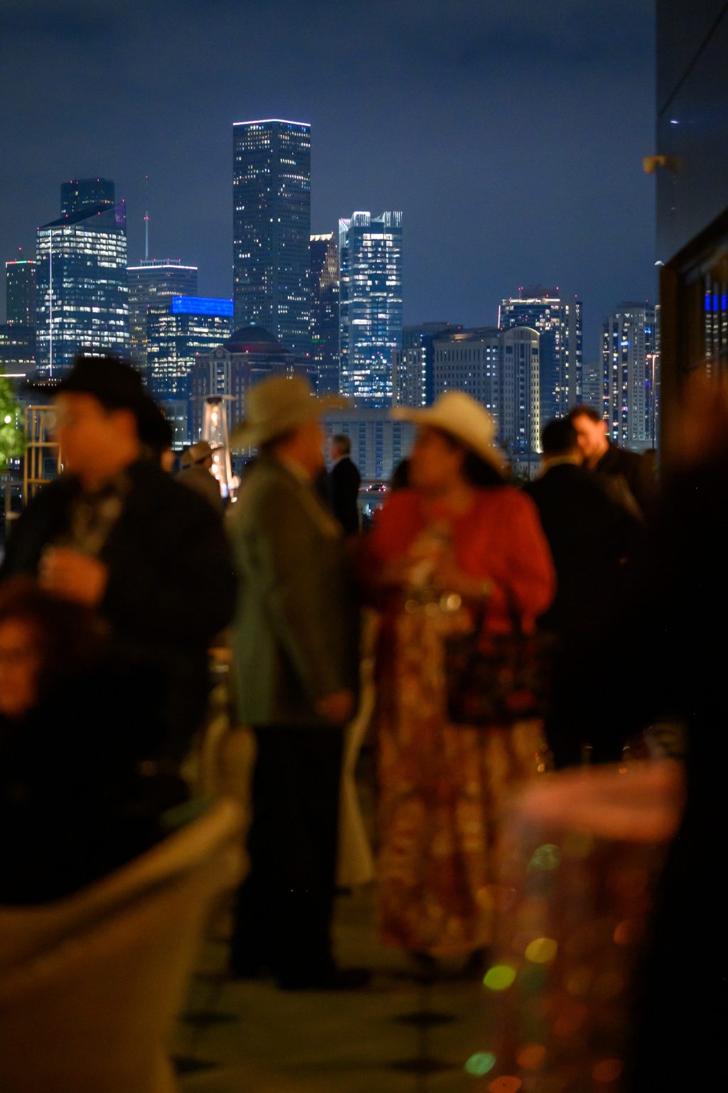 Guests enjoying the evening with the Houston skyline visible behind them.