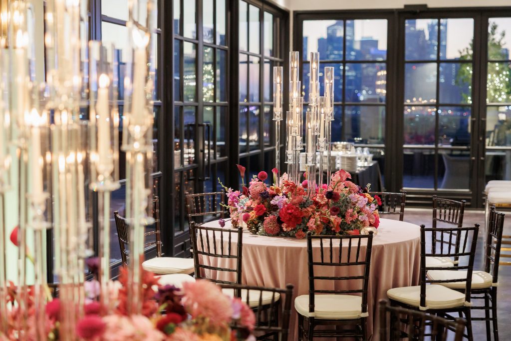 Reception table set with candles, florals, and layered decor at Le Tesserae.
