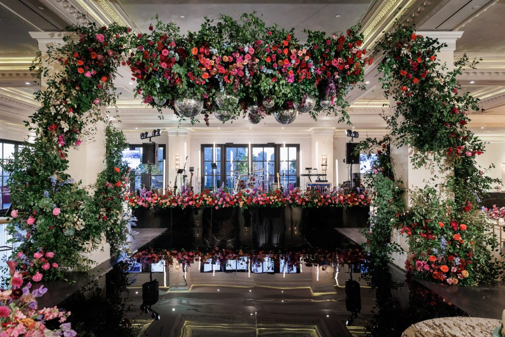Large floral arrangement framing the reception space at the Houston wedding.