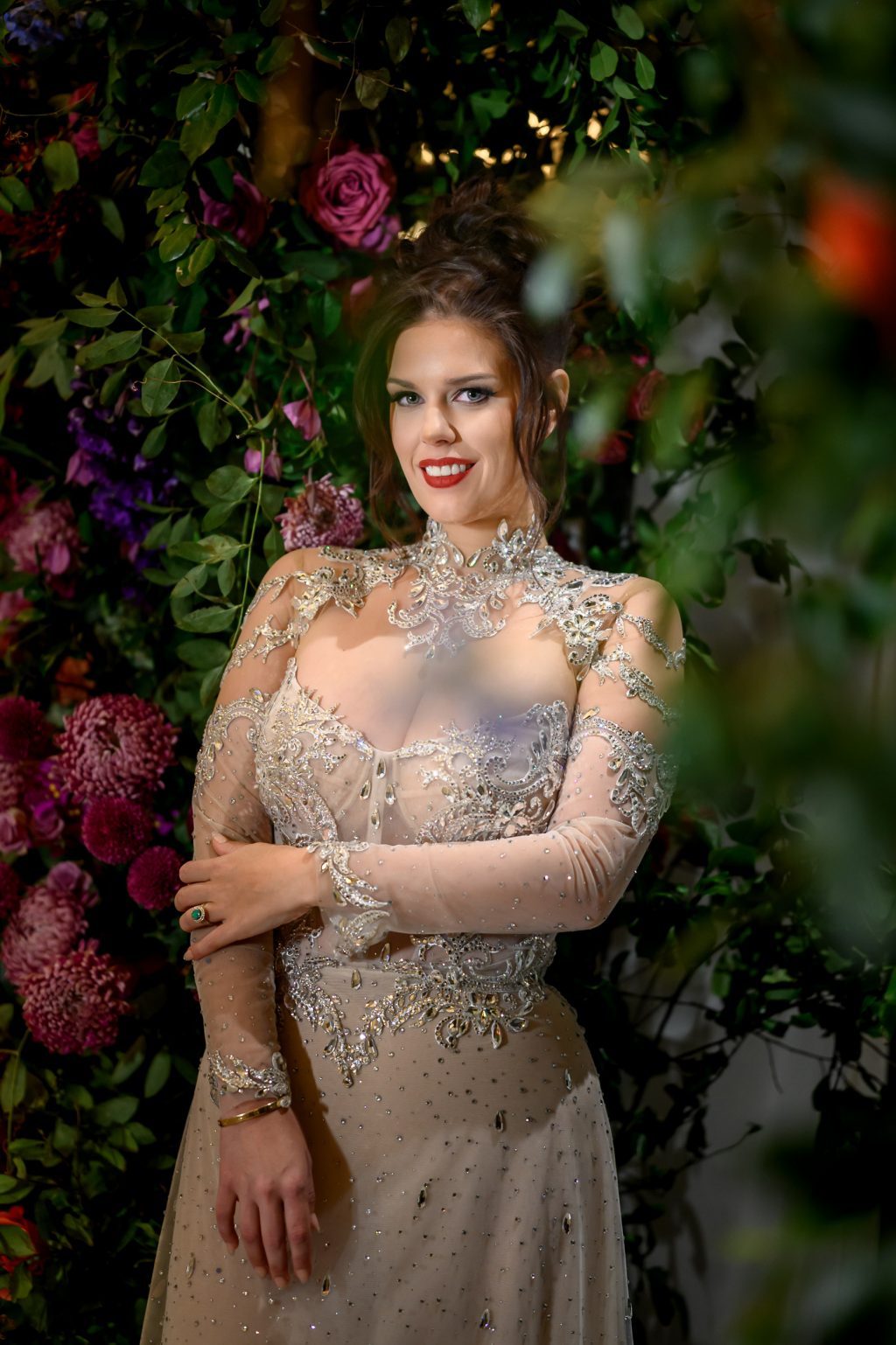 Bride posing beside dramatic florals during her reception at Le Tesserae.