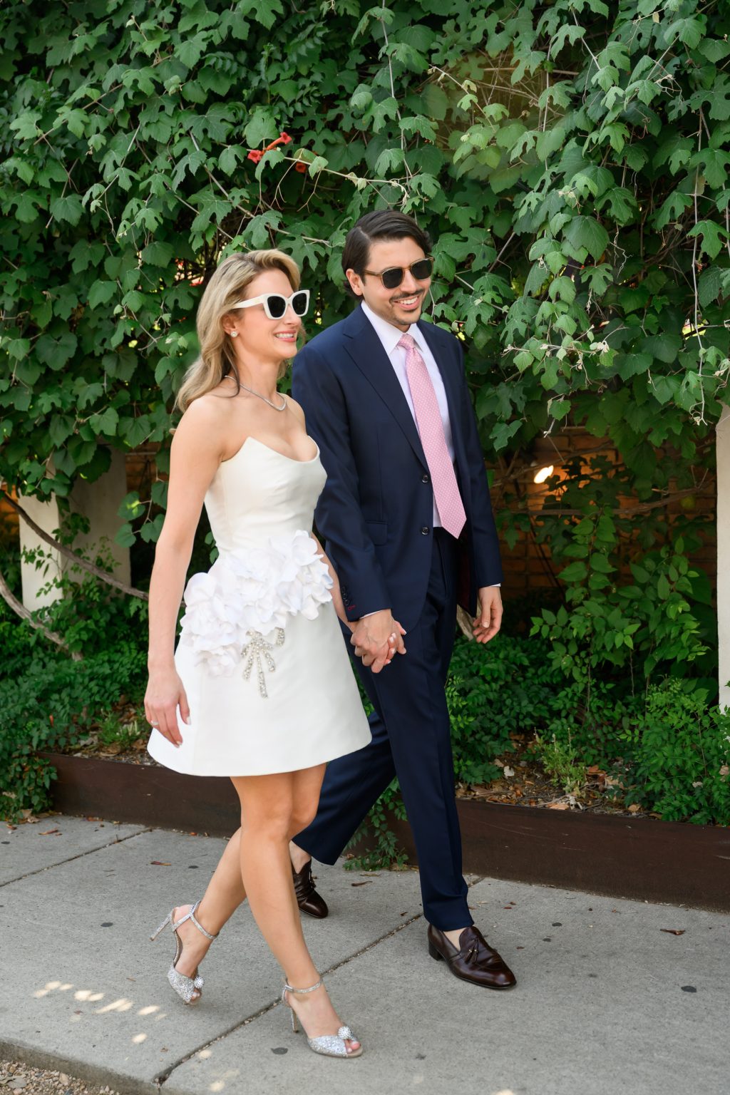 Bride in Badgley Mischka Floral Appliqué Strapless Cocktail Dress and groom in suit during Austin wedding weekend