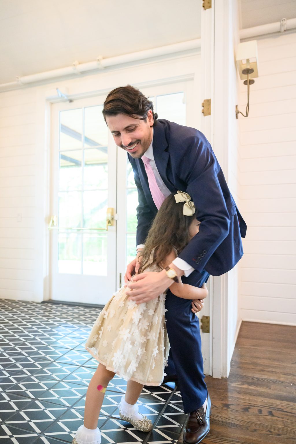 Groom sharing a candid moment with a niece during the wedding weekend