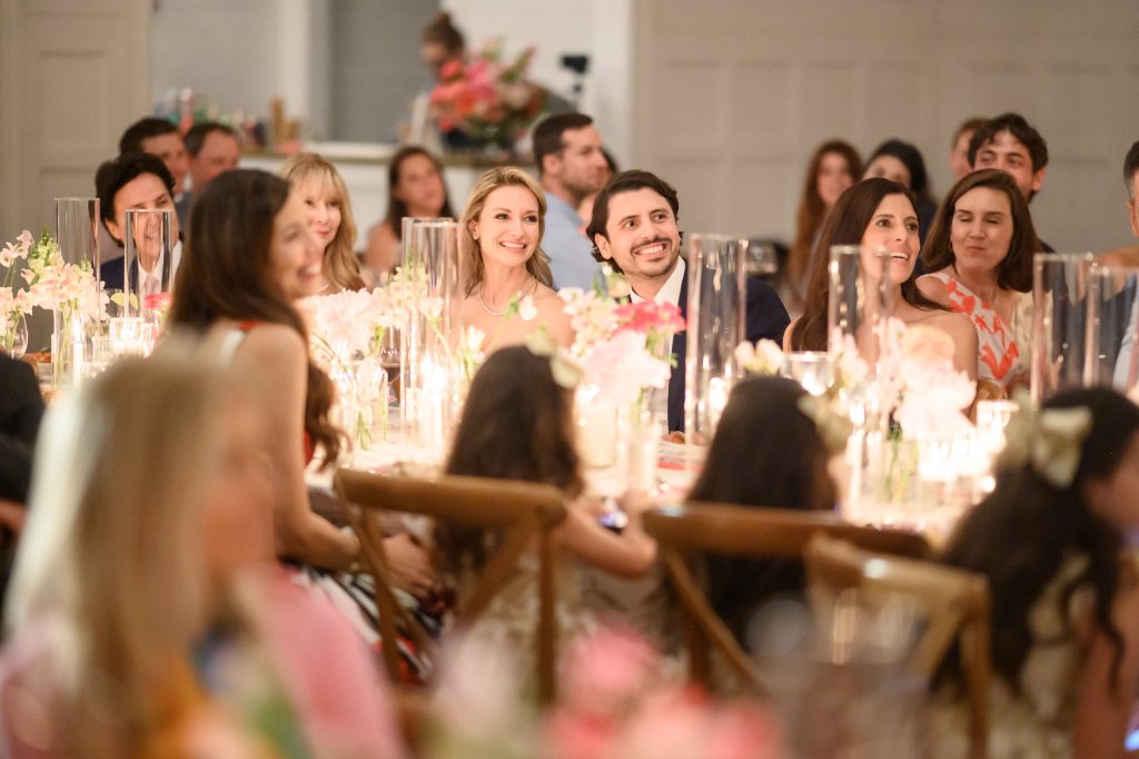 Guests gathered around a floral dinner table during an Austin wedding weekend at Mattie's