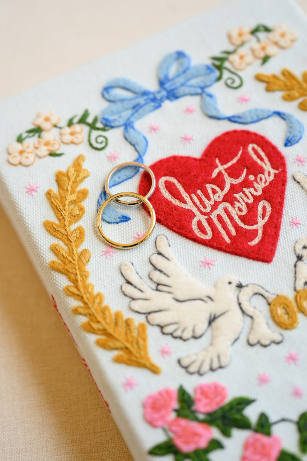 Olympia Le Tan embroidered doves clutch carried by the bride
