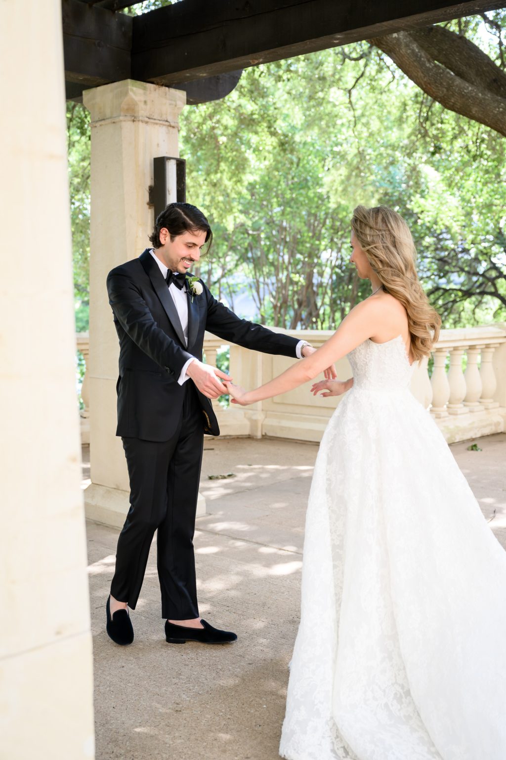 Bride and groom holding hands during wedding portraits in Austin