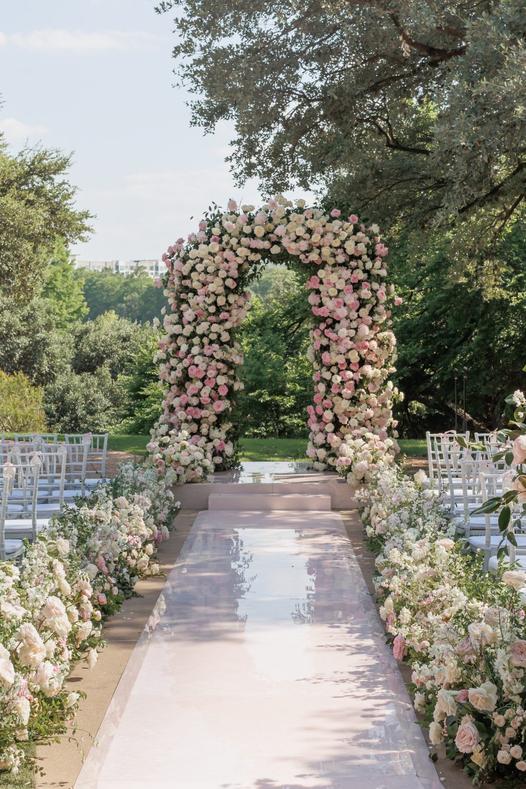 Four Seasons Austin lawn wedding ceremony with pink acrylic aisle