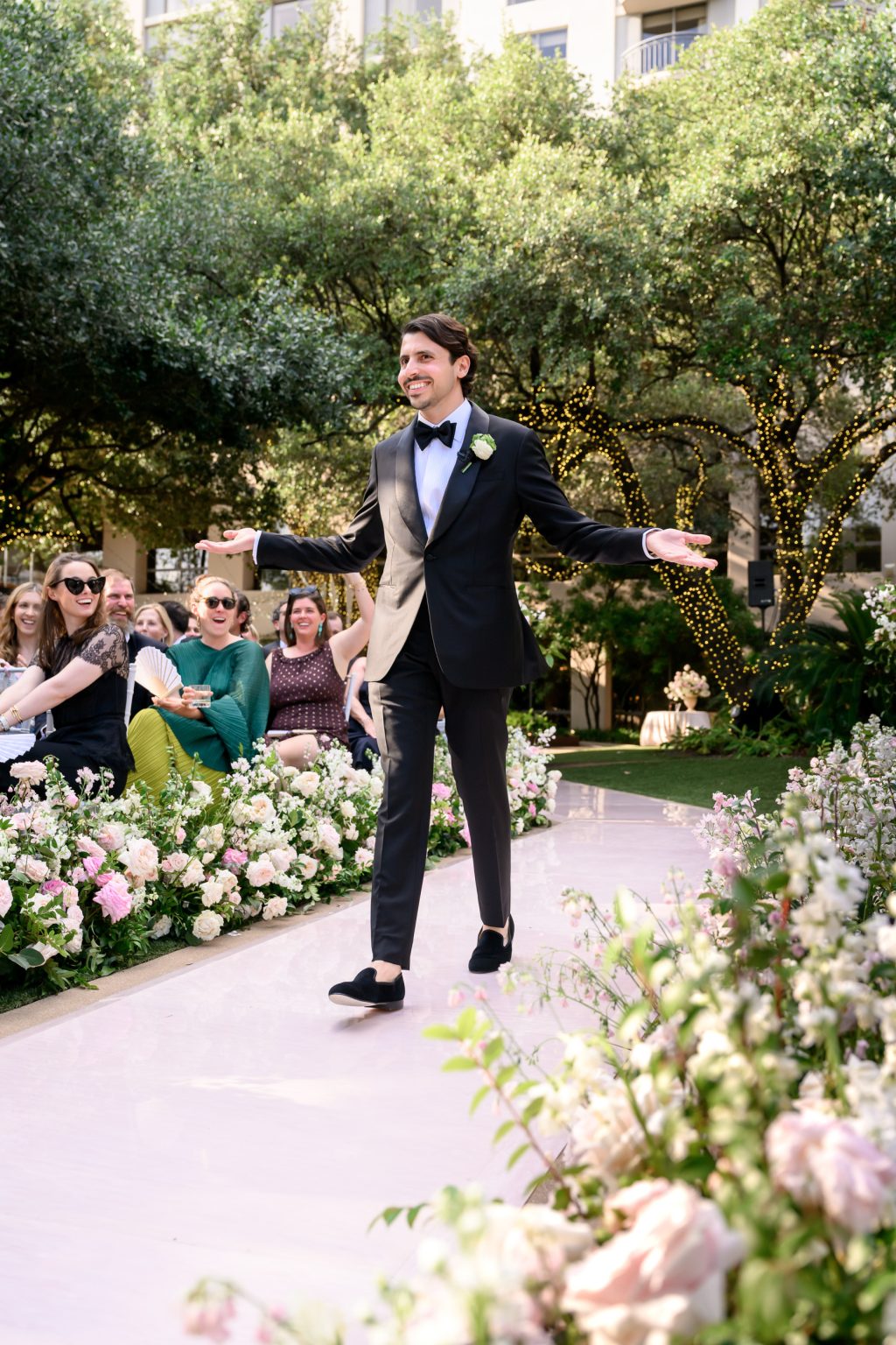 Groom reacting during an outdoor wedding ceremony at Four Seasons Austin