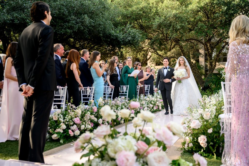 Bride walking down the aisle during a garden wedding at Four Seasons Austin