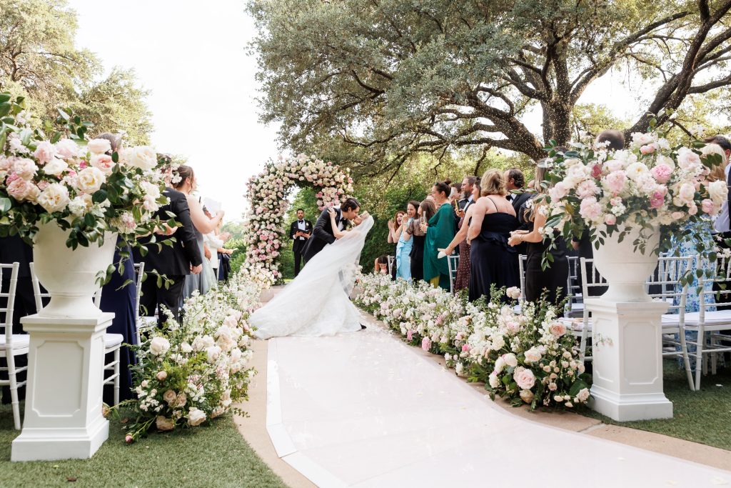 Bride walking down the aisle during an outdoor Four Seasons Austin ceremony