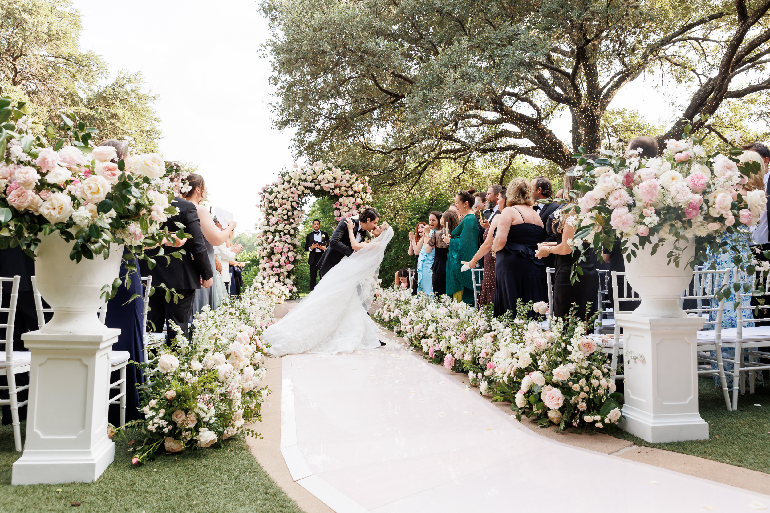 Outdoor wedding ceremony beneath the oak trees on the Four Seasons Austin Lawn