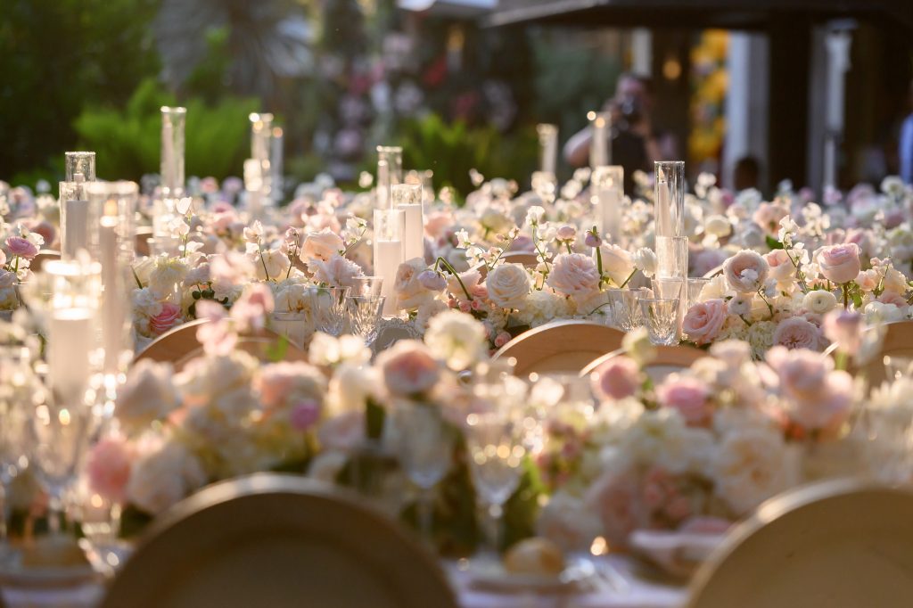 Candlelit wedding tablescape with soft pink and white floral details