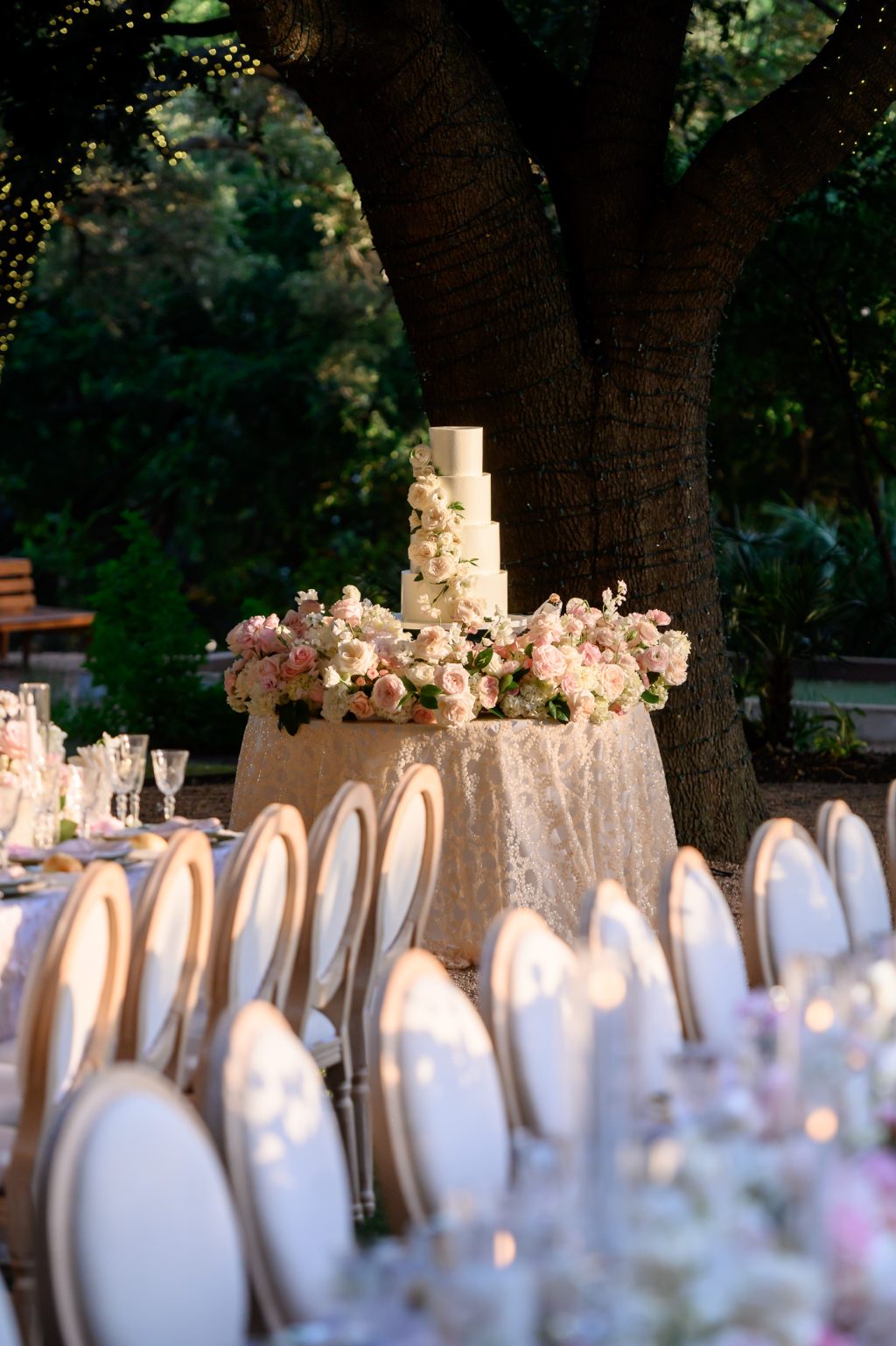 Pink and shite florals around the 4 tiered wedding cake