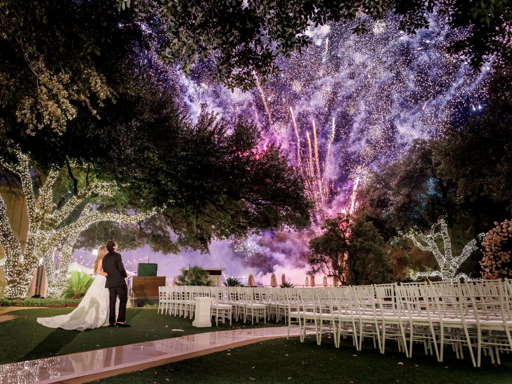 Fireworks over the Four Seasons Austin lawn after outdoor wedding dinner