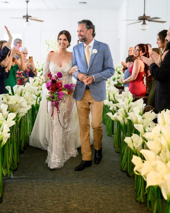 Calla lilly lined pathway at the church as the couple exits their wedding ceremony