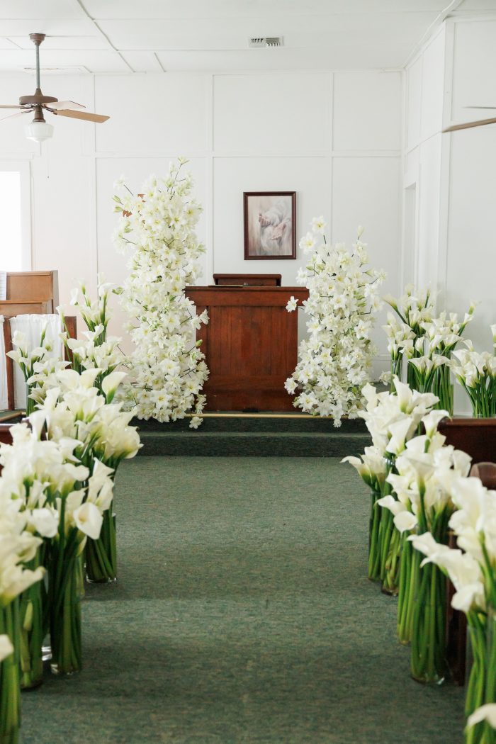 Inside the small historic texas church withe the aisle lined with calla lillies