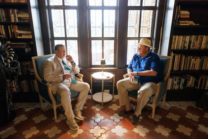 guests chatting in the library of the private estate