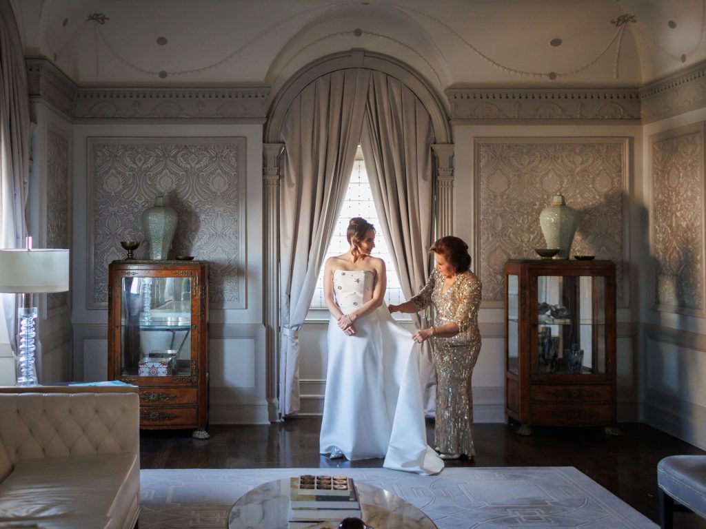 Bride getting ready with her mother in the Presidential suite at The St. Anthony Hotel