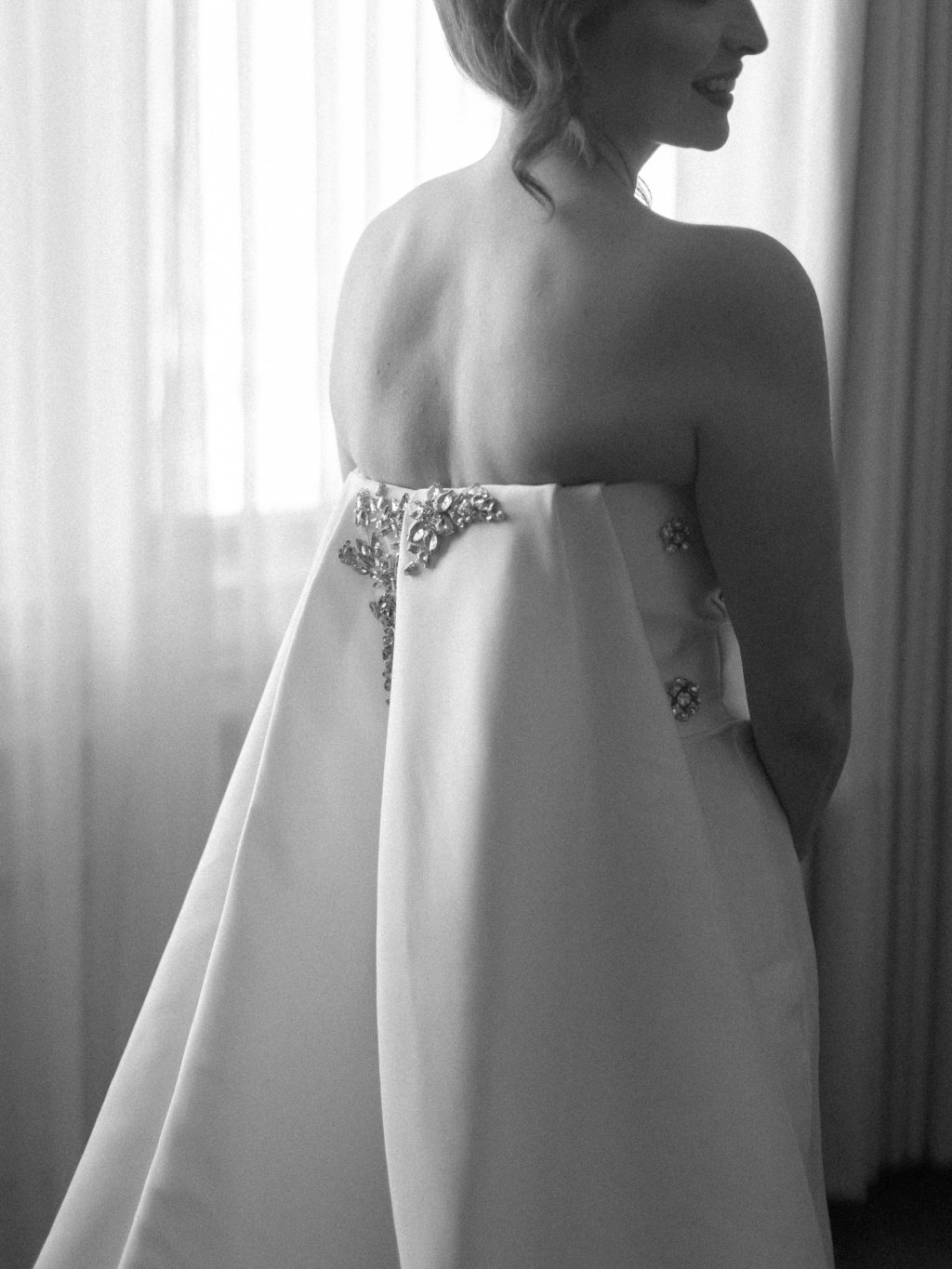 Black and white bridal portrait beside a window in John Wayne Suite at The St. Anthony Hotel