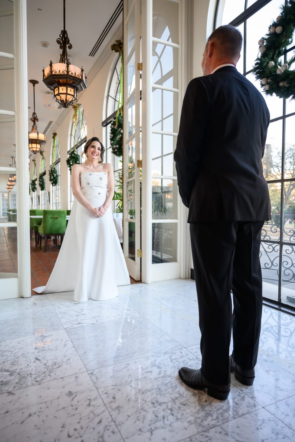 Groom seeing the bride for the first time in Gallery on the Park at The St. Anthony Hotel