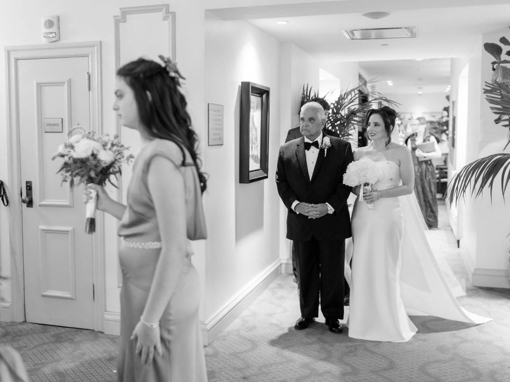 Bride walking with her father before the ceremony at The St. Anthony Hotel