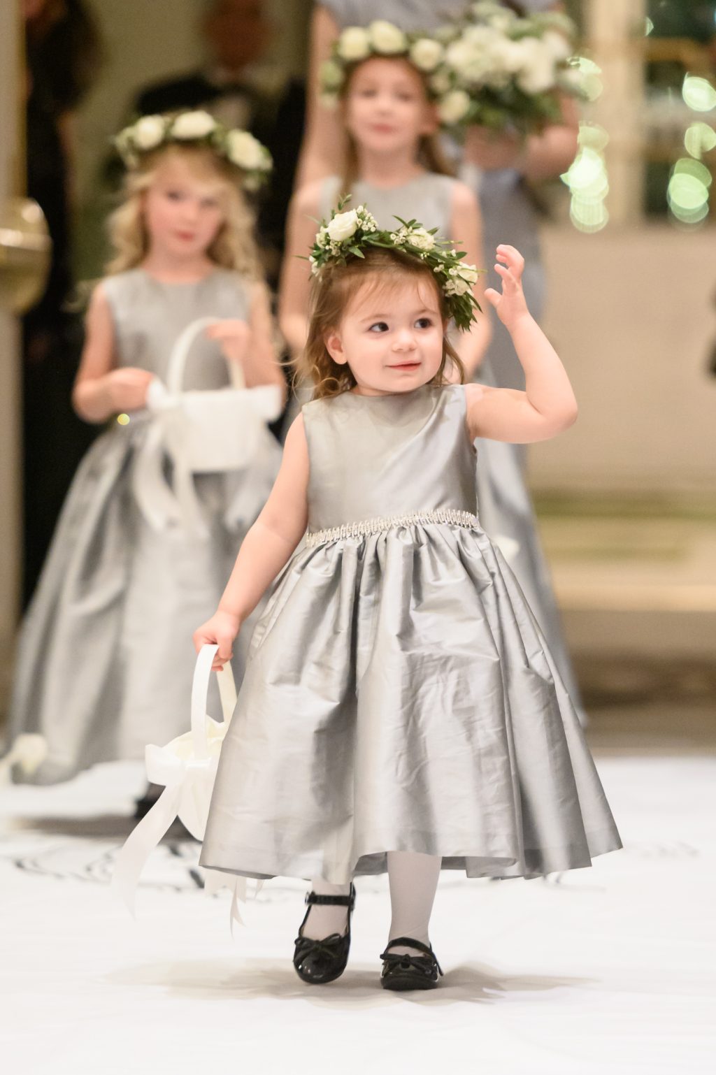 Flower girl walking down the aisle during a New Year’s Eve wedding in San Antonio