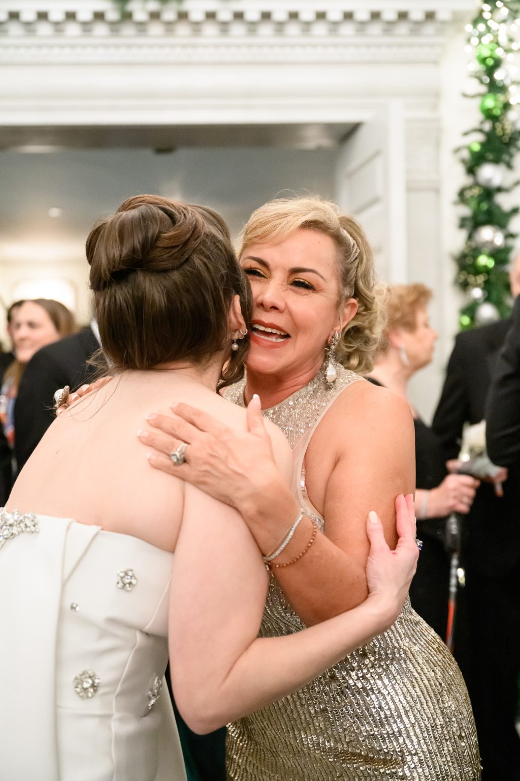 Bride embracing her mother during the wedding celebration at The St. Anthony Hotel 1025 Guests at The St. Anthony Hotel Wedding Bride and groom greeting guests during their New Year’s Eve wedding reception 1026 New Year’s Eve Wedding Entertainment Performers in white feather costumes during a New Year’s Eve wedding at The St. Anthony Hotel 1027 White Floral Centerpiece in [BALLROOM NAME] Tall white and green floral centerpiece designed for the reception in [BALLROOM NAME] 1028 New Year’s Eve Wedding Escort Display Black and white escort card display at a New Year’s Eve wedding planned by Wilkinson Rhodes 1029 [BALLROOM NAME] Wedding Reception Design White floral reception design beneath chandeliers in [BALLROOM NAME] at The St. Anthony Hotel 1030 New Year’s Eve Wedding Cocktails Specialty cocktails served during the New Year’s Eve reception at The St. Anthony Hotel 1031 [BALLROOM NAME] Wedding at The St. Anthony Wedding reception with white flowers, greenery and crystal chandeliers in [BALLROOM NAME] 1032 San Antonio Wedding Reception in [BALLROOM NAME] Candlelit reception with white florals and greenery inside [BALLROOM NAME] at The St. Anthony Hotel 1033 New Year’s Eve Reception in [BALLROOM NAME] Evening view of the New Year’s Eve wedding reception inside [BALLROOM NAME] 1034 White Floral Wedding Tablescape Reception table with white flowers, greenery and crystal glassware at The St. Anthony Hotel 1035 Dinner in [BALLROOM NAME] at The St. Anthony Guests seated for dinner during the New Year’s Eve wedding reception 1036 First Dance in [BALLROOM NAME] Bride and groom dancing on a black and white dance floor inside [BALLROOM NAME] 1037 Black and White First Dance Photograph Black and white photograph of the bride and groom’s first dance at The St. Anthony Hotel 1038 New Year’s Eve Wedding in [BALLROOM NAME] Guests watching the couple dance during a packed New Year’s Eve reception 1039 First Dance Beneath the Chandeliers Bride and groom dancing beneath chandeliers during their St. Anthony Hotel wedding reception 1040 Father Daughter Dance at The St. Anthony Black and white photograph of the bride dancing with her father 1041 Father Daughter Dance in [BALLROOM NAME] Bride dancing with her father while guests watch from the ballroom balcony 1042 New Year’s Eve Wedding Dinner Guests gathered around long dinner tables during a New Year’s Eve wedding at The St. Anthony Hotel 1043 Candid Reception Photograph Bride laughing with guests during dinner at her San Antonio wedding 1044 New Year’s Eve Wedding Performers Wedding entertainers during the New Year’s Eve reception at The St. Anthony Hotel 1045 [BALLROOM NAME] New Year’s Eve Wedding Packed wedding reception and dance floor inside [BALLROOM NAME] at The St. Anthony Hotel 1046 New Year’s Eve Wedding Dance Floor Bride wearing New Year’s Eve glasses while dancing with guests 1047 New Year’s Eve Wedding Celebration Wedding guest celebrating on the dance floor at The St. Anthony Hotel 1048 Happy New Year Wedding Celebration Black and white photograph of a wedding guest wearing Happy New Year glasses 1049 Bride and Groom Dancing on New Year’s Eve Bride and groom kissing while dancing during their New Year’s Eve reception 1050 New Year’s Eve Party at The St. Anthony Bride dancing with guests during the New Year’s Eve wedding celebration 1051 Candid Wedding Dance Floor Guest laughing on the dance floor during the St. Anthony Hotel wedding 1052 New Year’s Eve Reception at The St. Anthony Guest dancing with purple tinsel during the New Year’s Eve reception 1053 Midnight Confetti in [BALLROOM NAME] Wedding guests celebrating beneath a burst of confetti at midnight in [BALLROOM NAME] 1054 Bride and Groom Midnight Kiss Bride and groom kissing beneath confetti during their New Year’s Eve wedding 1055 Midnight Confetti Dance Floor Bride and groom dancing with guests as confetti falls at midnight 1056 Midnight Celebration at The St. Anthony Bride celebrating with wedding guests during the New Year’s Eve confetti drop 1057 Bride Dancing at Her New Year’s Eve Wedding Bride dancing beneath confetti during her St. Anthony Hotel wedding 1058 New Year’s Eve Wedding Guest Portrait Wedding guests wearing festive New Year’s Eve hats during the late night celebration 1059 Bride at the New Year’s Eve After Party Bride celebrating during the late night wedding after party at The St. Anthony Hotel 1060 New Year’s Eve Wedding Performer Performer in a mirrored costume during the New Year’s Eve wedding celebration