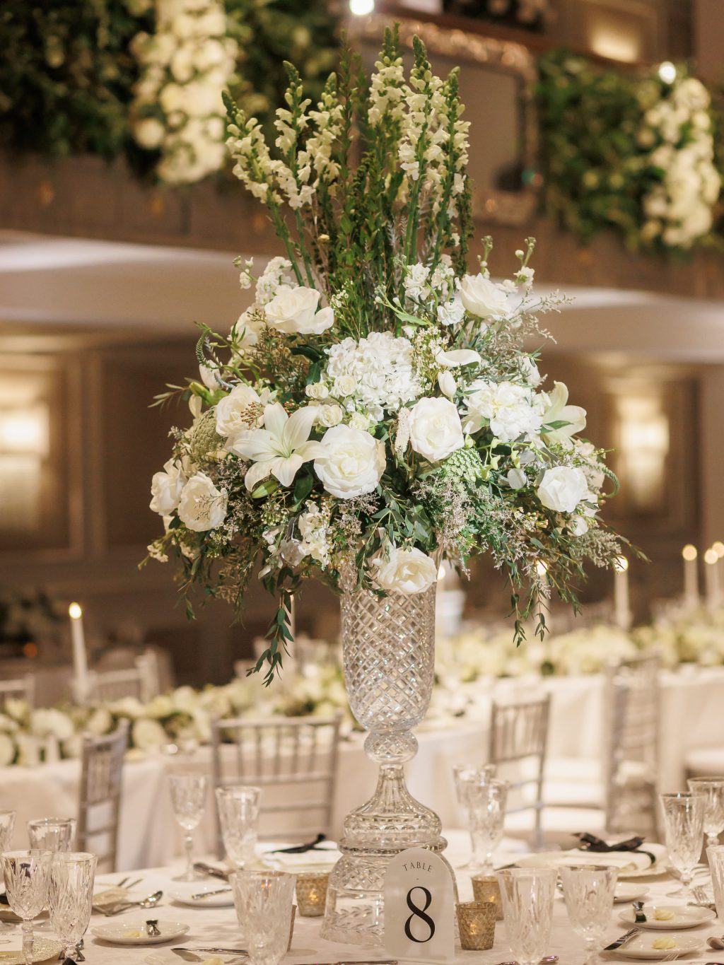 Tall white and green floral centerpiece designed for the reception in the Anacacho Ballroom