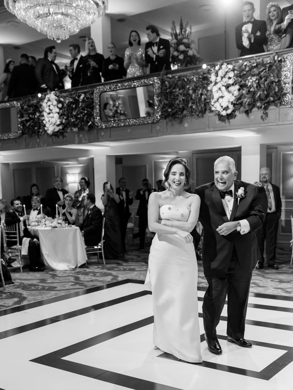 Black and white photograph of the bride dancing with her father by photojournalist Jenny DeMarco