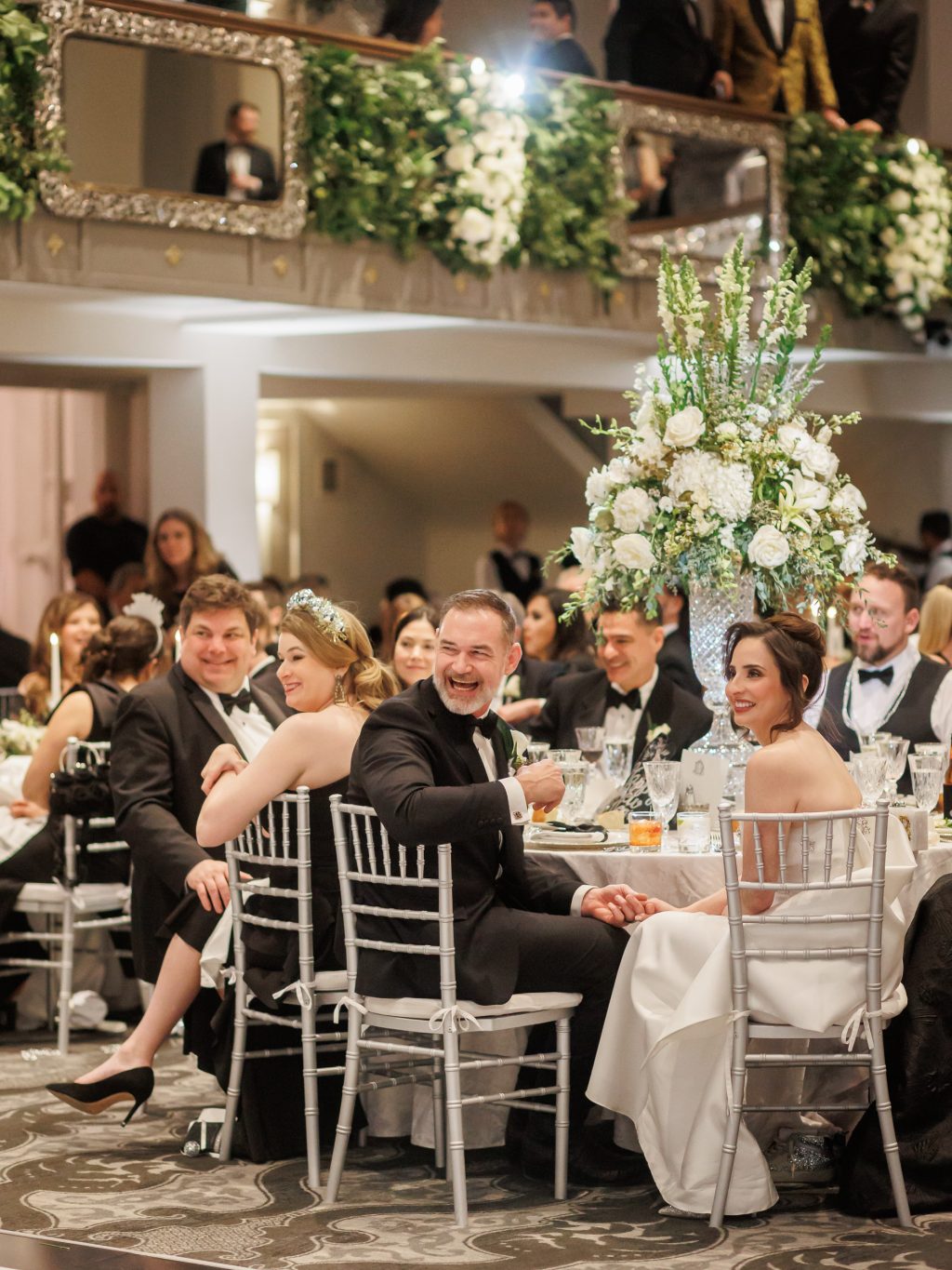 Bride laughing with guests during dinner at her San Antonio wedding