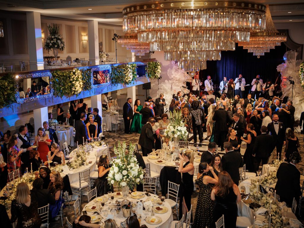 Guests gathered around long dinner tables during a New Year’s Eve wedding at The St. Anthony Hotel
