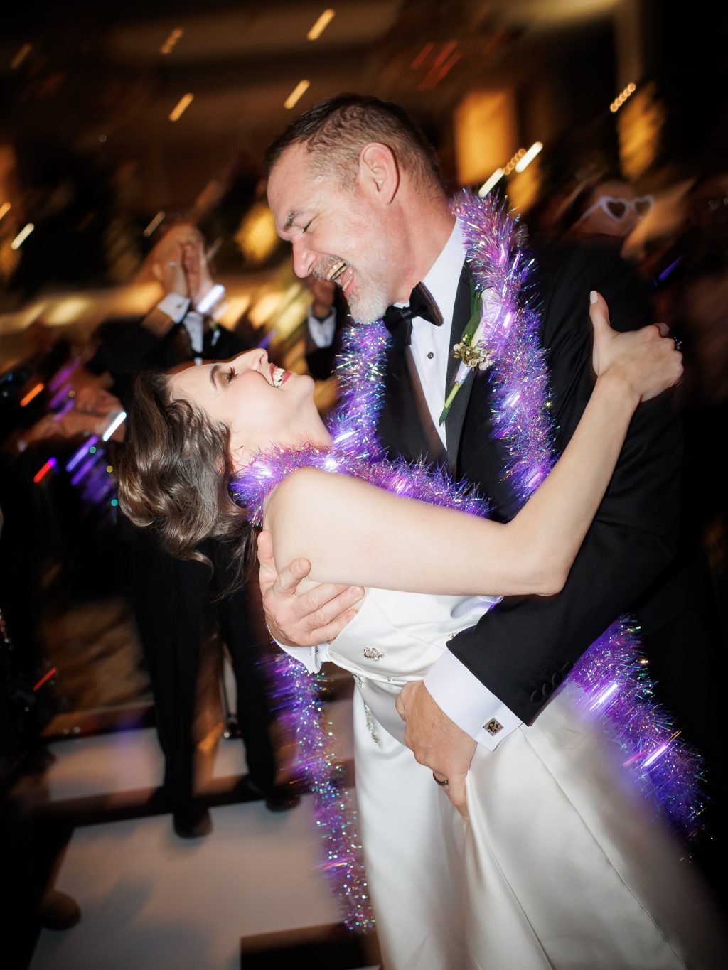 Bride and groom kissing while dancing during their New Year’s Eve reception