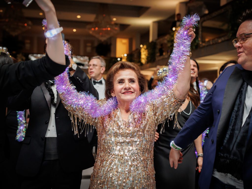 grandma dancing with purple tinsel during the New Year’s Eve reception