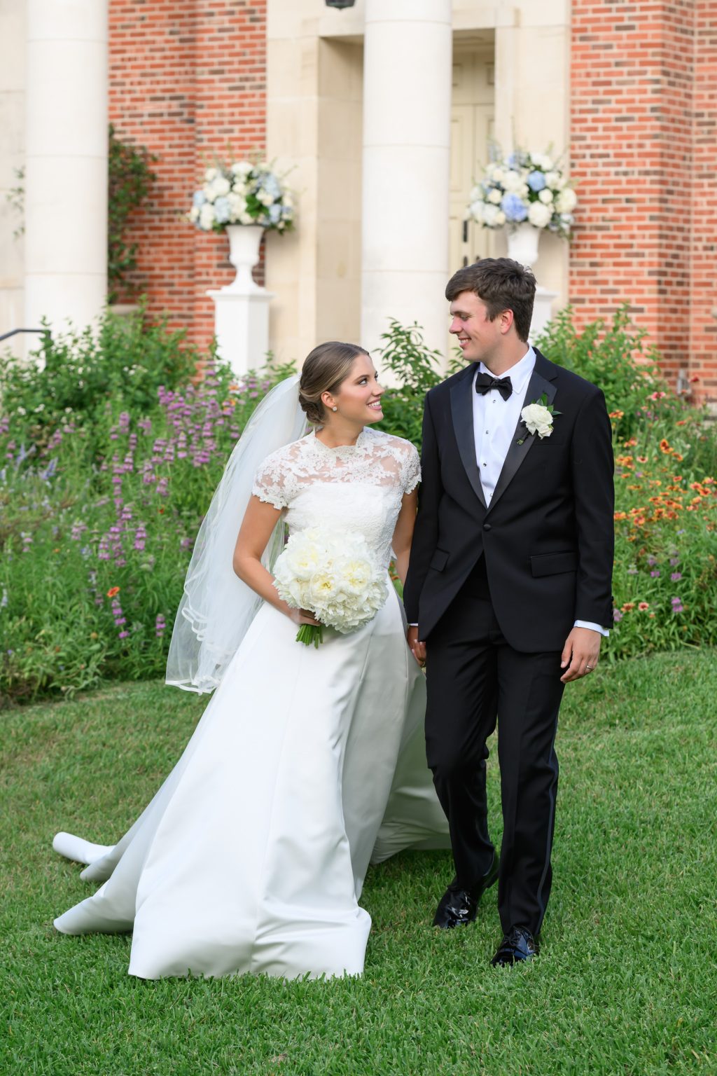 Bride and groom portrait outside Tarrytown United Methodist Church following their traditional Austin wedding ceremony