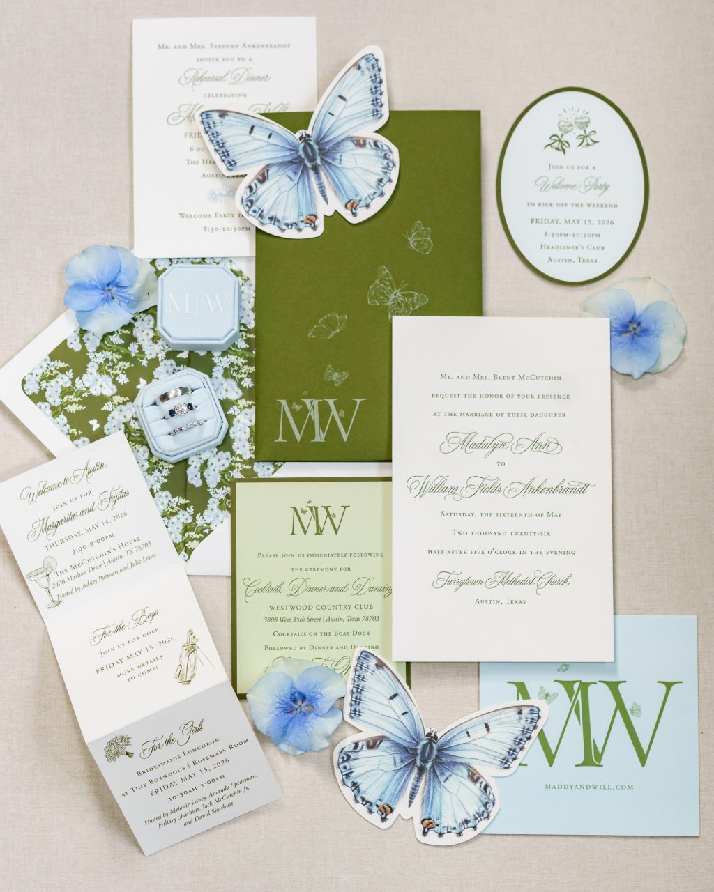Classic blue and green wedding stationery with illustrated butterflies and a custom monogram